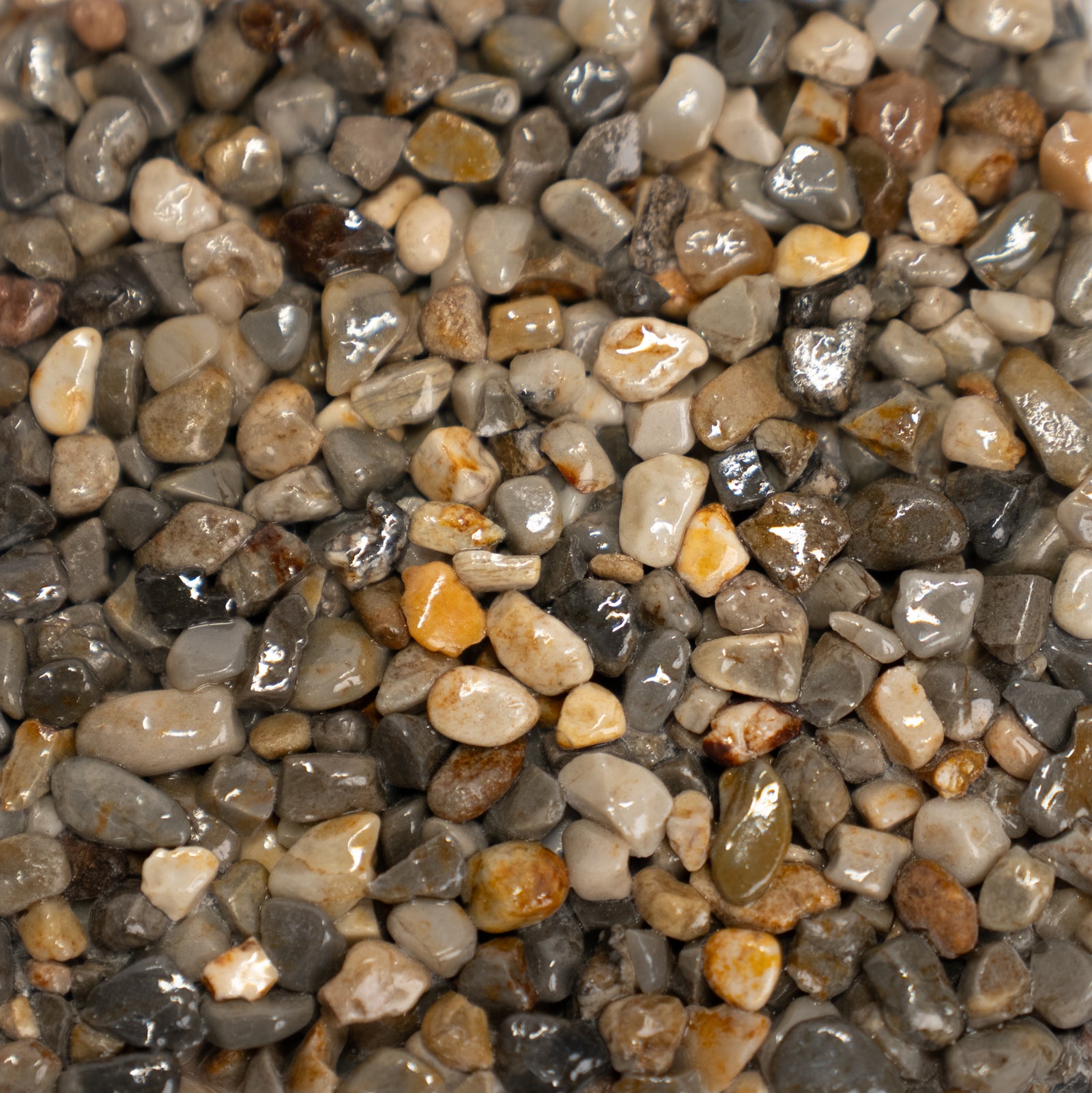 Multicolored gray stones that range from light to dark gray with hints of pink, red and orange colors.