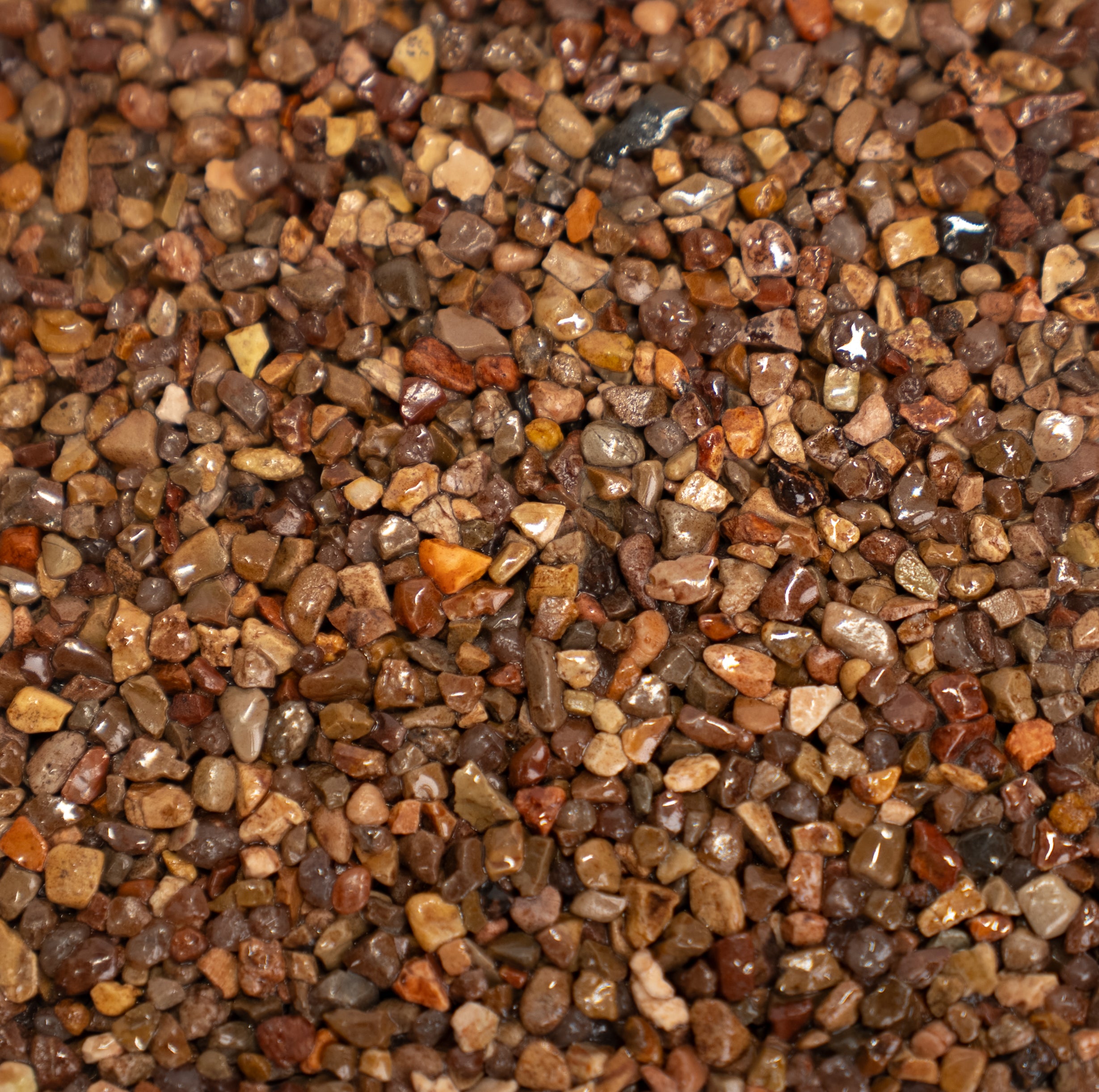 Close-up of small pebbles in various shades of brown and orange.